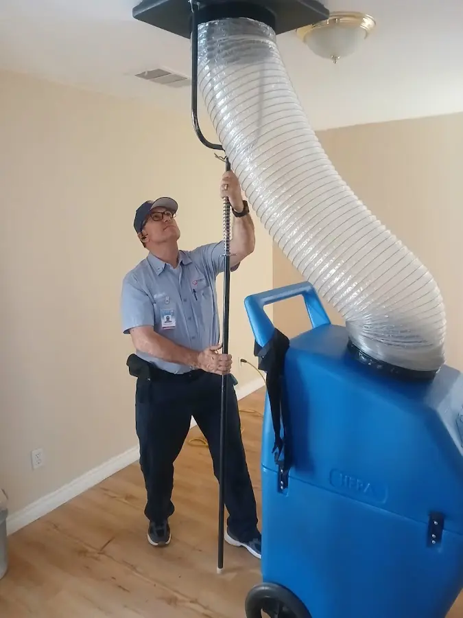 Furnace Tune-Up technician using HEPA equipment in Canfield